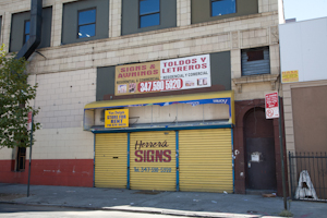 Shuttered sign shop, Bathgate neighborhood, Bronx. Photo by Pat Arnow