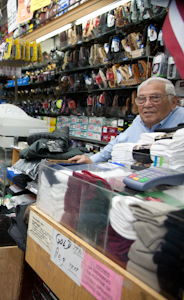 Moe Stein, 83, at the counter of his store, Frank's Sports. He is the son of the original owner. Photo by Pat Arnow.